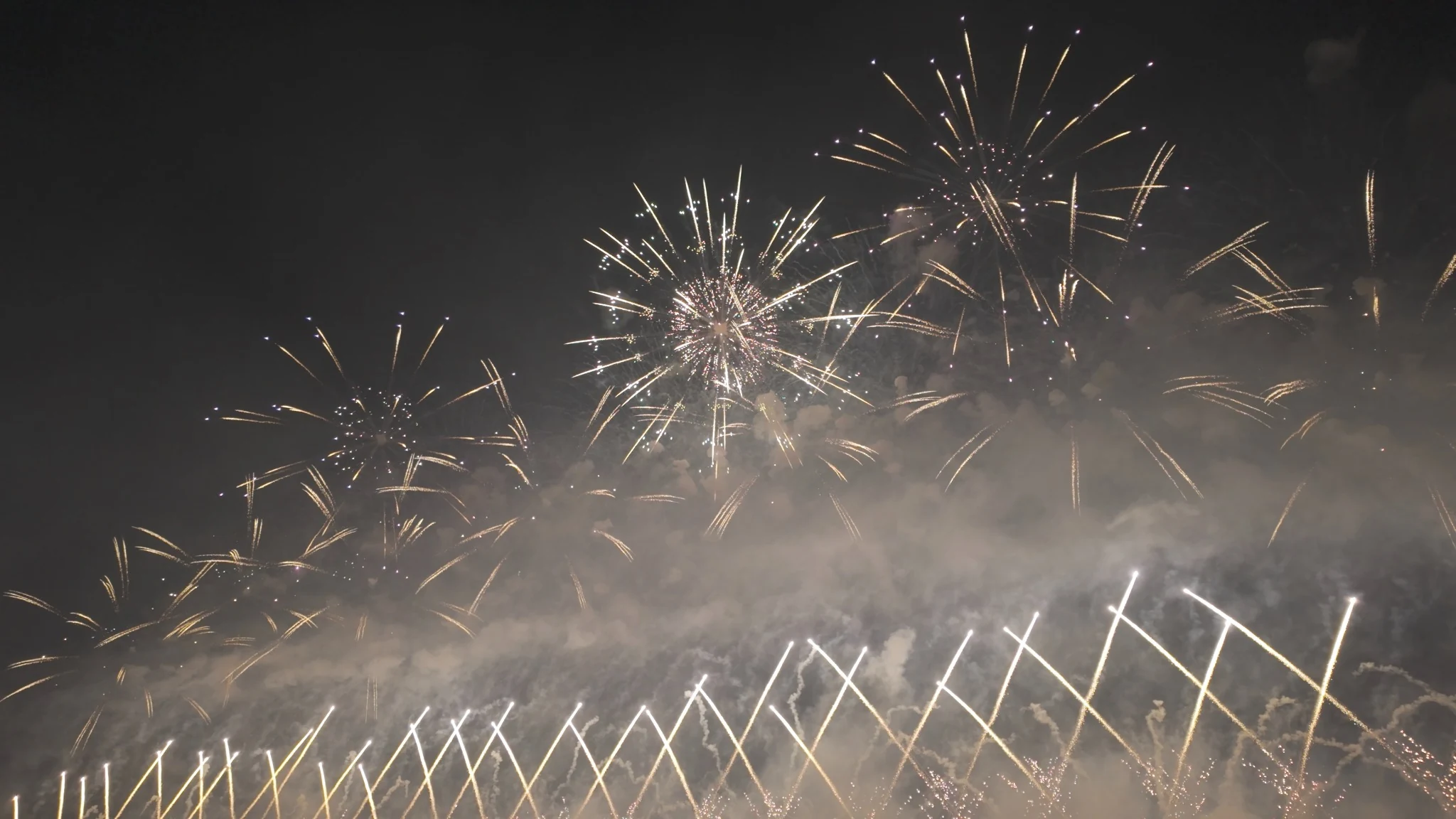 Layered golden fireworks crossing above Omagari