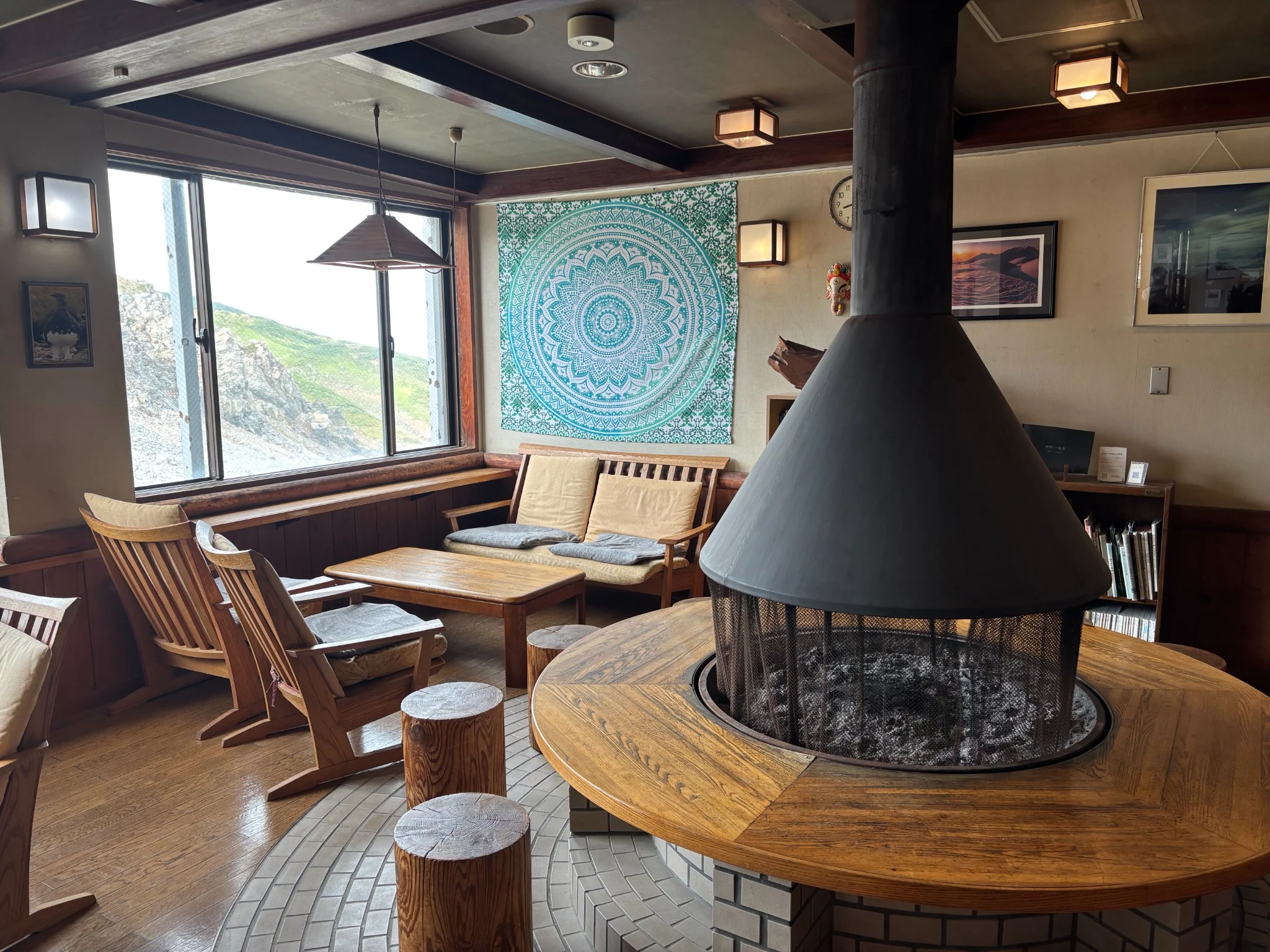 Wooden lounge at Raichoso with a central fireplace and mountain view