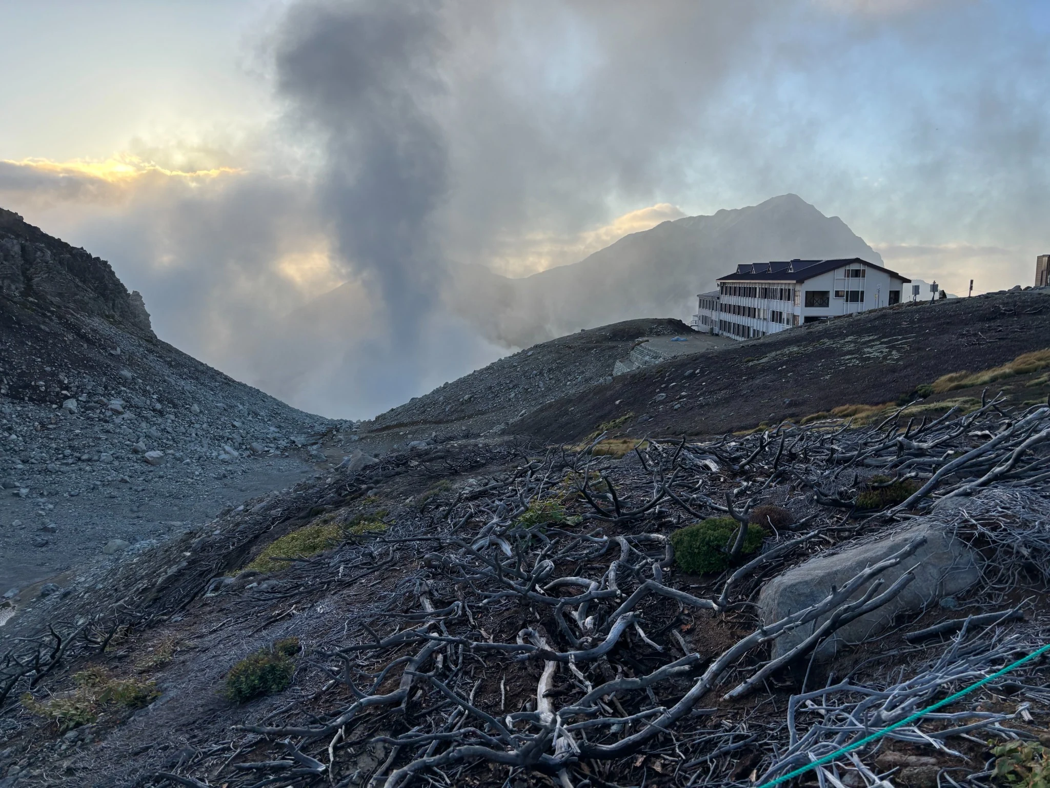Raichoso mountain lodge beside volcanic steam in the evening light